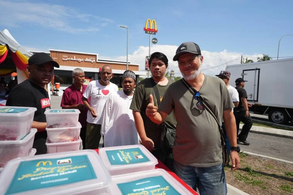 Sebahagian daripada penerima sumbangan daging korban dan Kotak Rezeki ceria ketika menerima sumbangan itu yang diagihkan di restoran McDonald's Batu Buruk, Kuala Terengganu.