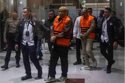 Asrul Azis Taba (tengah memegang tongkat) dan Ismail Adham, diiringi pegawai KPK ketika dibawa keluar dari ibu pejabat suruhanjaya itu di Jakarta pada 8 Jun 2026. Foto: Antara