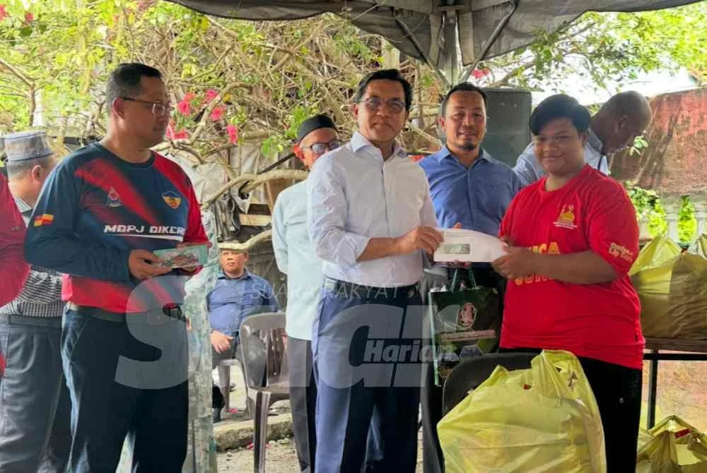 Zulkifle (tengah) menyampaikan sumbangan tunai kepada mangsa kebakaran Muhammad Arif Haikal Mohd Termizi, 18.
FOTO ADILA SHARINNI WAHID