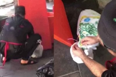 Tangkap layar video tular memaparkan pekerja restoran berkenaan bertindak memasukkan seekor kucing ke dalam guni.