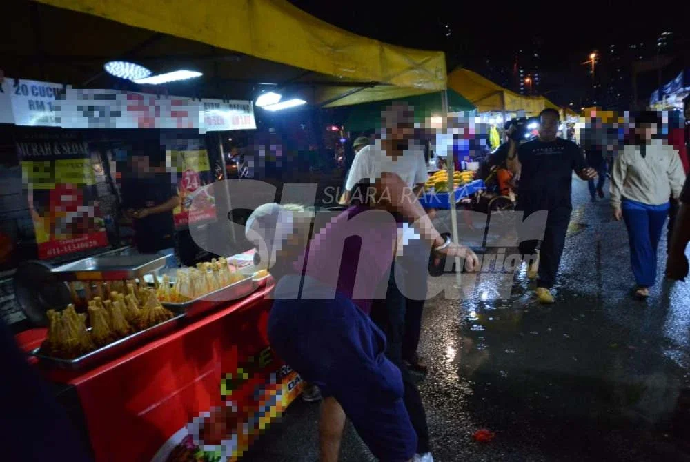 Berlaku pergelutan melibatkan seorang lelaki warga asing yang dipercayai cuba melarikan diri ketika ditahan. Foto: ASRIL ASWANDI SHUKOR