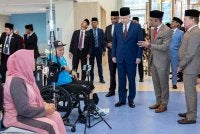 Sultan Nazrin berkenan menyantuni salah seorang pesakit ketika baginda melawat bilik rawatan selepas merasmikan Pusat Rehabilitasi Neuro-Robotik dan Cybernics Pertubuhan Keselamatan Sosial (PERKESO) di Meru Raya pada Selasa. Foto Bernama