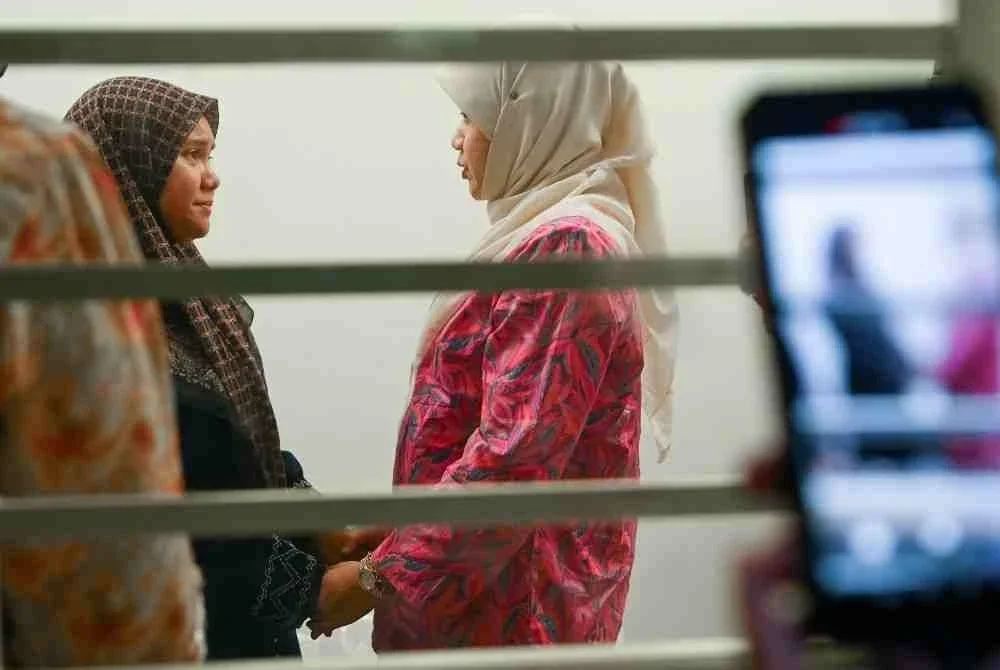 Menteri Pendidikan Fadhlina Sidek (kanan) menyantuni ibu kepada pelajar perempuan berusia 16 tahun yang ditemukan tidak sedarkan diri di sebuah sekolah menengah di daerah ini ketika mengunjungi Unit Forensik Hospital Rembau pada Jumaat. Foto Bernama.