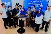Ab Raisham (empat dari kanan) menyaksikan Aniza menandatangani plak sebagai gimik perasmian pada Majlis Perasmian AI-Powered Classroom SMKA Naim Lilbanat di Kota Bharu. Foto SMKA NAIM LILBANAT