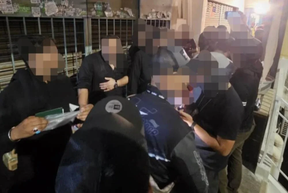 Antara individu yang diperiksa pihak berkuasa dalam serbuan di sebuah premis di Petaling Jaya pada Khamis.