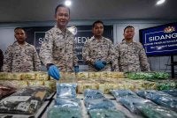 Pemangku Pengarah Maritim Johor Kepten Maritim Kama Azri Kamil (dua kiri) menunjukkan pil ekstasi dalam sidang media mengenai rampasan dadah dan tangkapan di Ibu Pejabat Maritim Negeri Johor, hari ini. Foto Bernama
