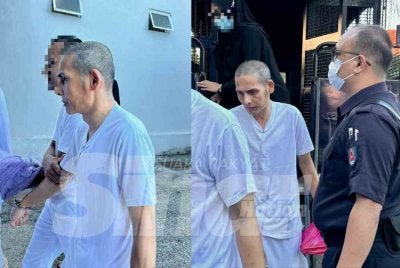 Amran (tengah) dikawal ketat polis keluar dari black maria sebaik tiba di mahkamah. 