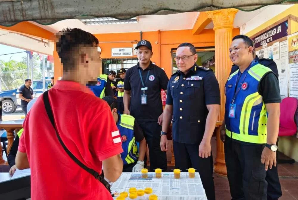 Stien (dua kanan) ketika menyiasat kelindan lori ais yang ditahan kerana positif dadah pada hari pertama dia bekerja pada Khamis.