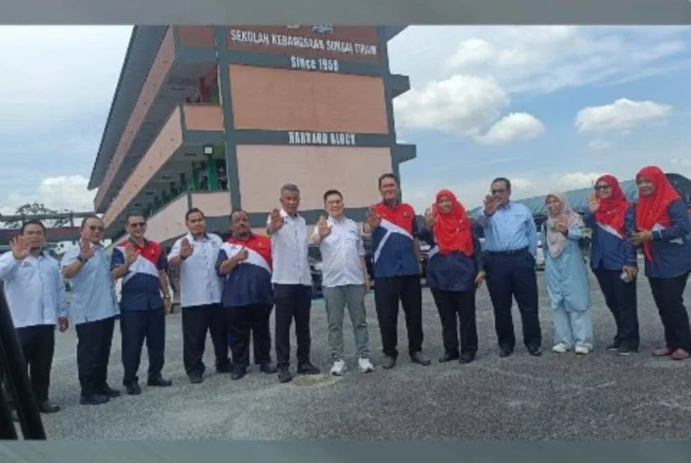 Kah Woh (tengah) ketika mengadakan lawatan ke ke sekolah di Johor. Foto: FB SK Sungai Tiram