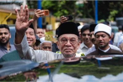 Perdana Menteri Datuk Seri Anwar Ibrahim melambaikan tangan kepada orang ramai selepas menunaikan solat Jumaat di Masjid As-Sodiqin Taman Kobena, hari ini. Foto Bernama 