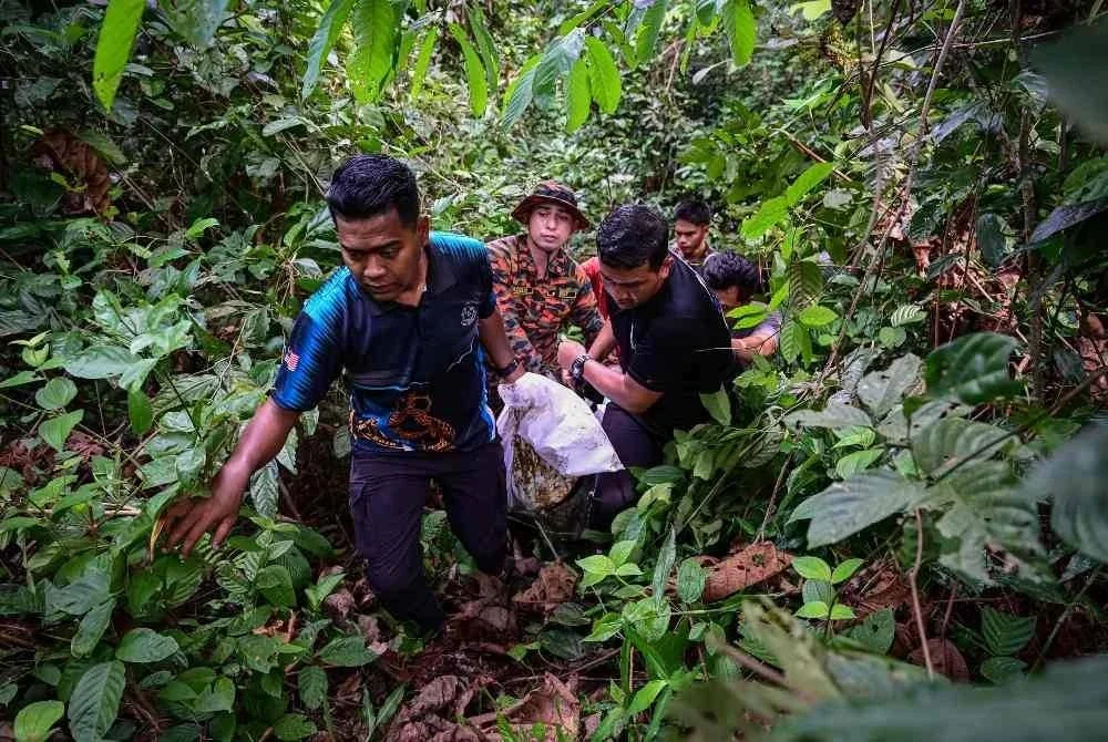 Pasukan penyelamat mengusung mayat seorang wanita yang terjatuh dari jambatan Sungai Paka di Jalan Jabor-Paka berhampiran Bandar Al Muktafi Billah Shah semalam setelah ditemukan lemas pagi ini. Foto Bernama