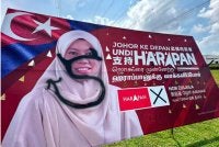 Papan iklan Nor Zulaila yang diconteng di Jalan Utama Kota Masai.