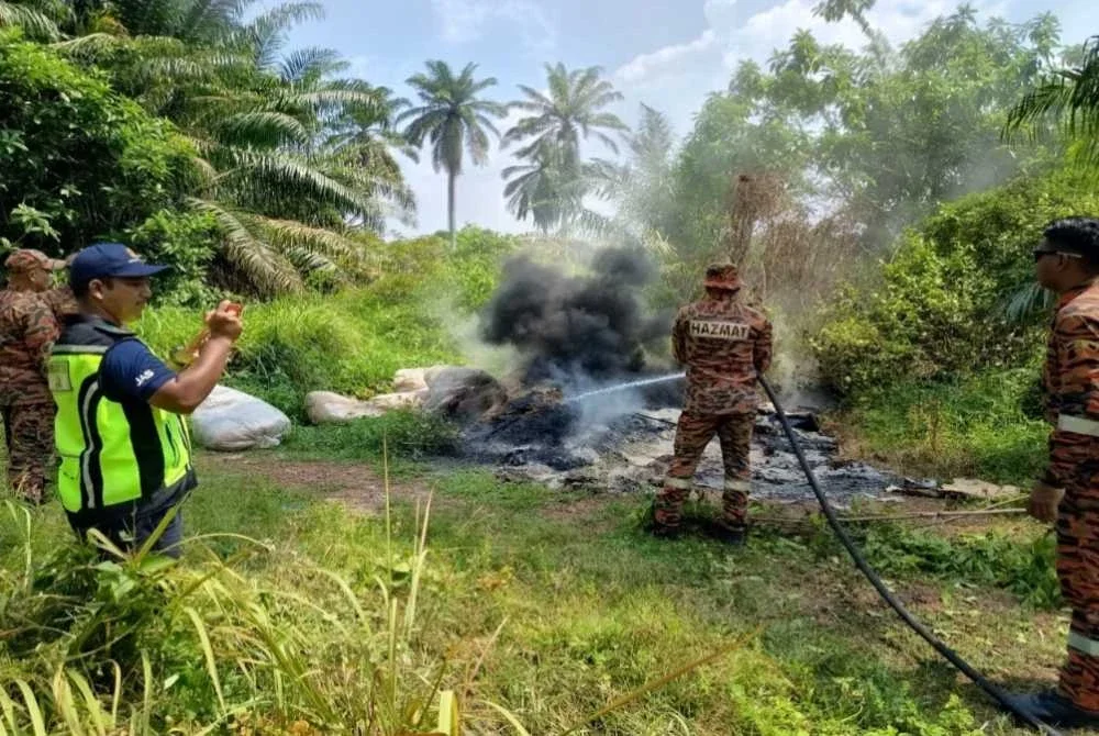 Pasukan bomba dipanggil untuk membantu memadam saki baki longgokan yang masih berasap. Foto JAS
