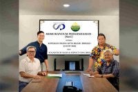 Nik Izani (duduk kanan) dan Roy Chok (duduk kiri) ketika menandatangani MoU antara COOP OKB dan Solartech Sales & Service Sdn Bhd pada Isnin.
