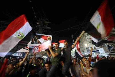 Mereka bersorak gembira sambil mengibarkan bendera kebangsaan Mesir ketika skuad The Pharaohs menjaringkan gol.
