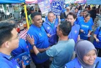 Abdul Halim (tengah) beramah mesra bersama masyarakat Cina dan India di Taman Desa Jaya pada Ahad lalu.