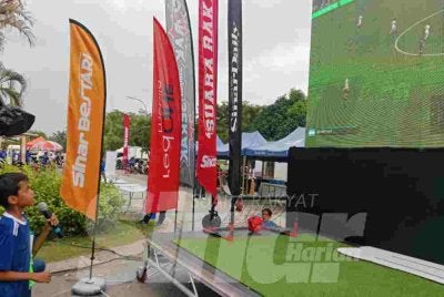 Salah seorang kanak-kanak menunjukkan bakat menerusi pertandingan Ulas Bola Pro redOne Mobile sempena program Riuh BOLA SINAR x redOne Mobile x RTM di Restoran Hakim, Seksyen 7, Shah Alam pada Ahad.