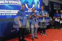 Saiful Yazan (kiri) menyerahkan baju kepada Mohamed Khaled sebagai simbolik pelancaran jentera BN Johol.
