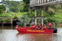 Anggota bomba menjalankan operasi pencarian di permukaan sungai. Foto: ADILA SHARINNI WAHID