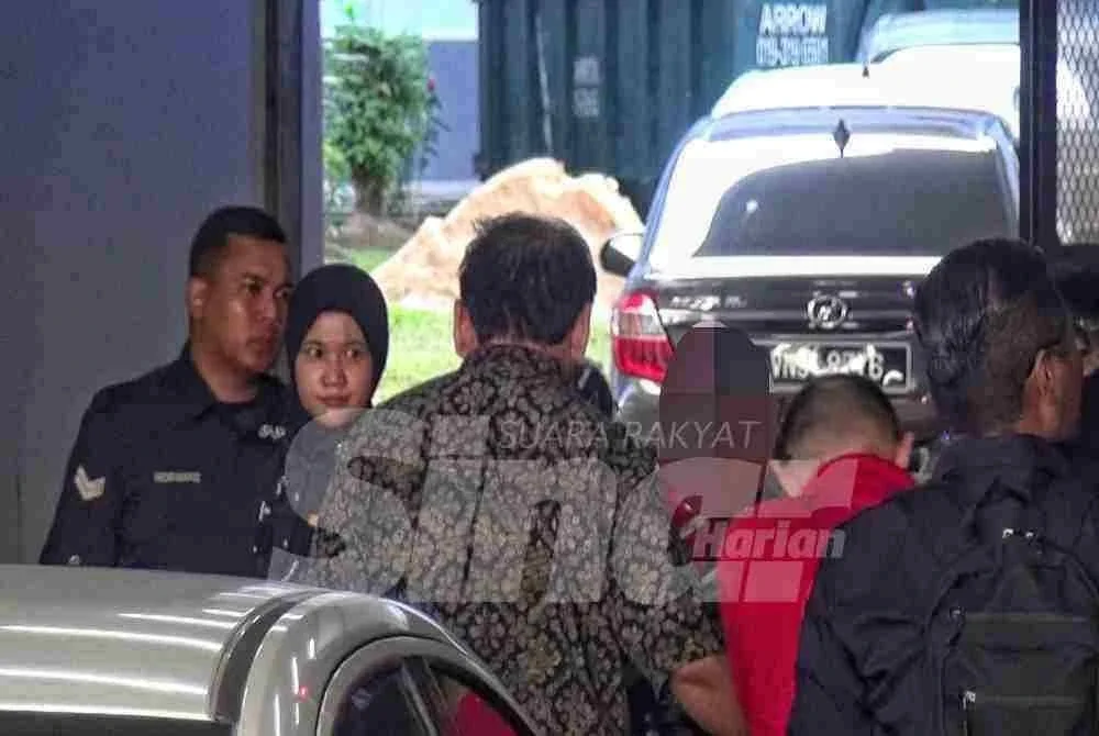 Suspek berbaju batik dibawa polis ke Mahkamah Seremban untuk permohonan reman.