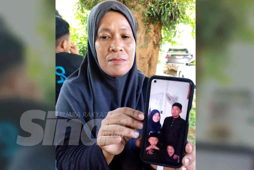 Noraida menunjukkan gambar arwah suami ketika ditemui di Unit Forensik Hospital Tanah Merah pada Selasa.