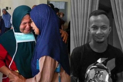 Ibu mangsa iaitu Rozita Ramli, 47, (kiri) tidak dapat menahan sebak sejurus mayat anaknya Mohd Ilham Che Mat Satar, 27, tiba di Hospital Gua Musang selepas ditemukan meninggal dunia di tepi Sungai Galas. Foto Bernama