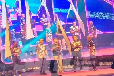 Tengku Muhammad (tengah) merasmikan Majlis Penyerahan Bendera Kontinjen Pahang ke SUKMA dan Para SUKMA di Dewan Jubli Perak Sultan Haji Ahmad Shah di sini pada Selasa