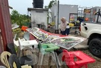 Nor Ayu melihat papan tanda kedai makannya yang jatuh dibadai angin kencang. 