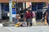 Syukur duduk di tepi jalan membuat persembahan mengharapkan sumbangan orang ramai yang menunggu lampu hijau untuk melintas jalan. 