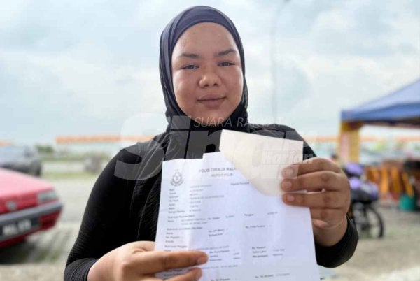 Juriana menunjukkan laporan polis dibuat susulan insiden menimpa suaminya. 