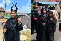 Roslina tampil memakai pakaian ala Maleficent mencuri perhatian di pusat mengundi SK Felda Palong 3 pada Sabtu.