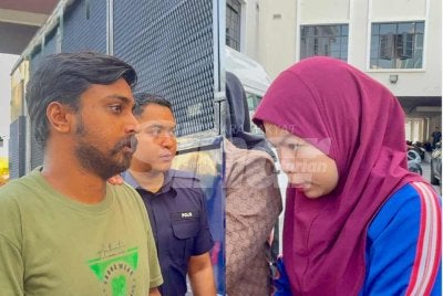 Kedua-dua tertuduh dibawa keluar dari Mahkamah Majistret 2 George Town selepas selesai pertuduhan pada Isnin. 