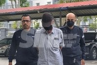 Law Tuan Hai dibawa polis ke Mahkamah Seremban pada Selasa.