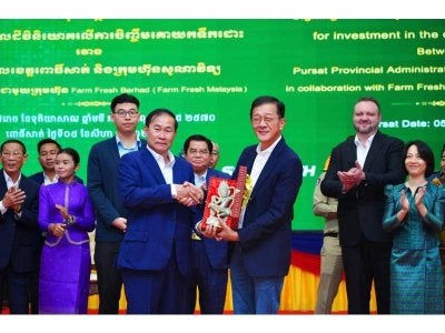 Pengarah Urusan Kumpulan merangkap Ketua Pegawai Eksekutif Kumpulan Farm Fresh Berhad, Loi Tuan Ee (kanan) dan Gabenor Wilayah Pursat, Khoy Rida (kiri) ketika meraikan majlis menandatangani memorandum persefahaman bagi projek Farm Fresh Pursat.