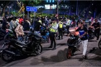  Anggota polis trafik memeriksa penunggang motosikal dan kenderaan mereka menerusi Ops Samseng Jalanan di Jalan Ampang awal pagi Ahad. Foto Bernama