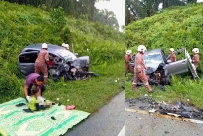 Anggota bomba mengeluarkan mangsa yang tersepit untuk menerima rawatan.