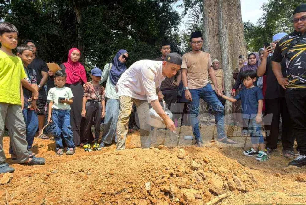 Saifulnizam menyiram air di pusara isterinya, Nur Fatimah Syuhada selepas selesai pengebumian pada petang Isnin. Foto SINAR HARIAN/NORAWAZNI YUSOF