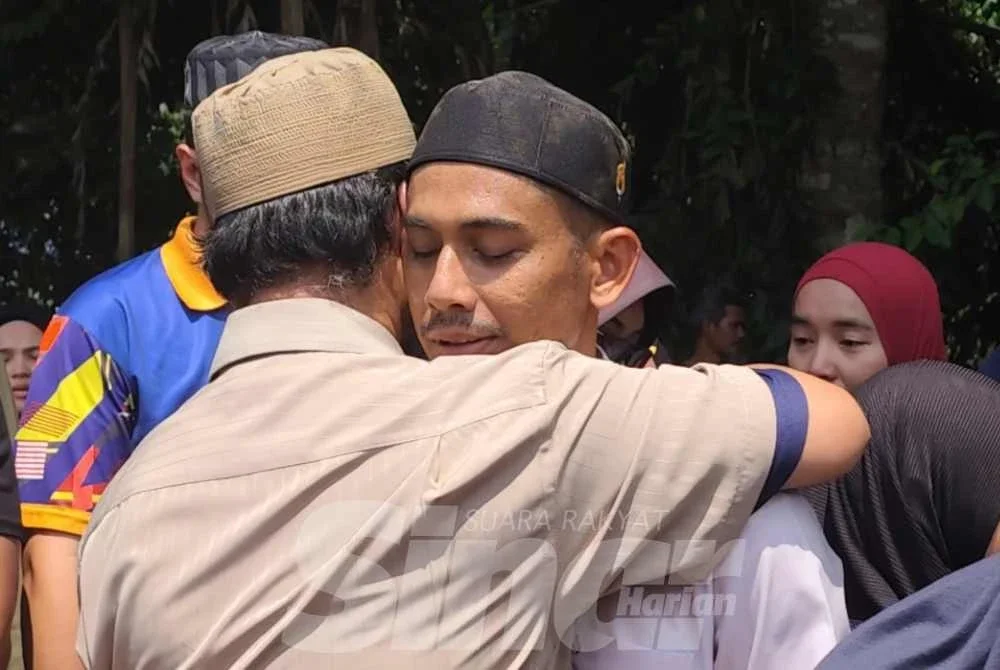 Saifulnizam ditenangkan selepas selesai urusan pengebumian insan tersayang di Tanah Perkuburan Islam Kampung Sanggang di sini pada Isnin. Foto Sinar Harian.