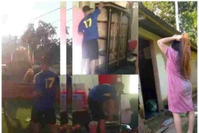 Seorang lelaki kelihatan mnegeluarkan perabut rumah sambil diperhatikan isterinya