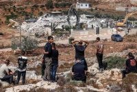 Lelaki Palestin menyaksikan jentolak Israel merobohkan sebuah bangunan milik Palestin atas alasan ketiadaan permit pembinaan di Qalandia, selatan Ramallah, Tebing Barat yang diduduki pada 17 Ogos 2026. Foto AFP