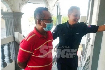 Tertuduh, Muhamad Fadzli Wahab, 48, ketika dihadapkan ke Majistret Sungai Petani pada Isnin. 