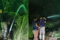 Anggota bomba goat memadamkan kebakaran tanah gambut di Jalan Bypass Punggai - Sebana Cove