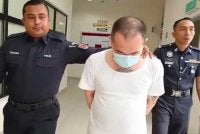 Yew Lung dibawa keluar oleh anggota polis dari mahkamah Tinggi Muar pada Rabu.