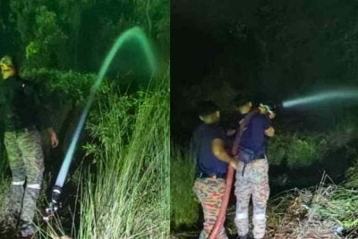 Anggota bomba goat memadamkan kebakaran tanah gambut di Jalan Bypass Punggai - Sebana Cove