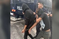 Dua mekanik termasuk seorang OKU lembam dibawa keluar dari Mahkamah Majistret Kulai pada Khamis