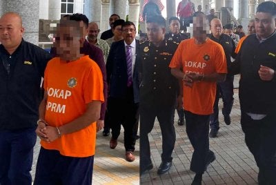 Orang yang disyaki diiringi pegawai SPRM bagi pernohonan reman pada Khamis.