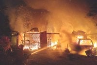 Anggota bomba memadamkan kebakaran sebuah garaj kenderaan di Jalan Bernam Tanjong Karang pada Khamis.