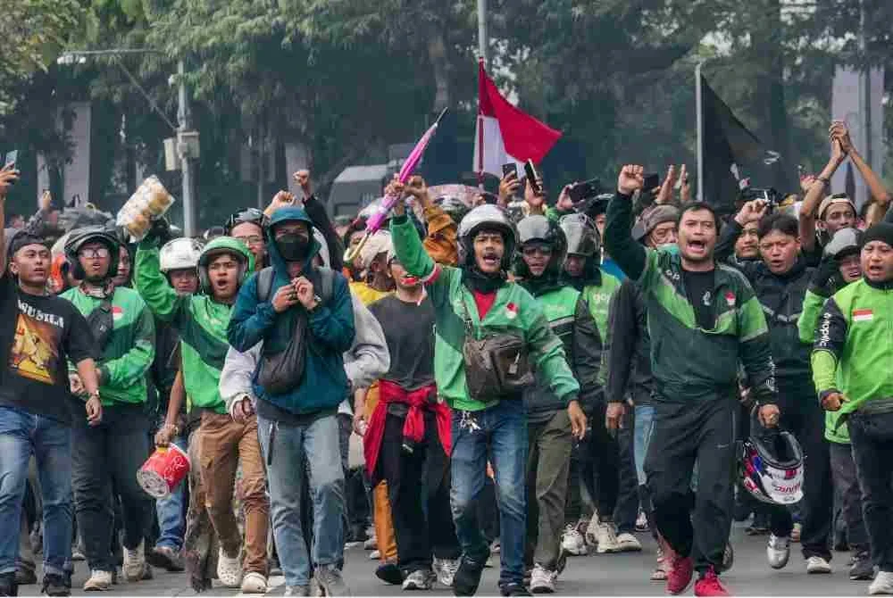 Penunggang motosikal e-hailing turut menyertai demonstrasi di luar bangunan Parlimen. Foto: AFP
