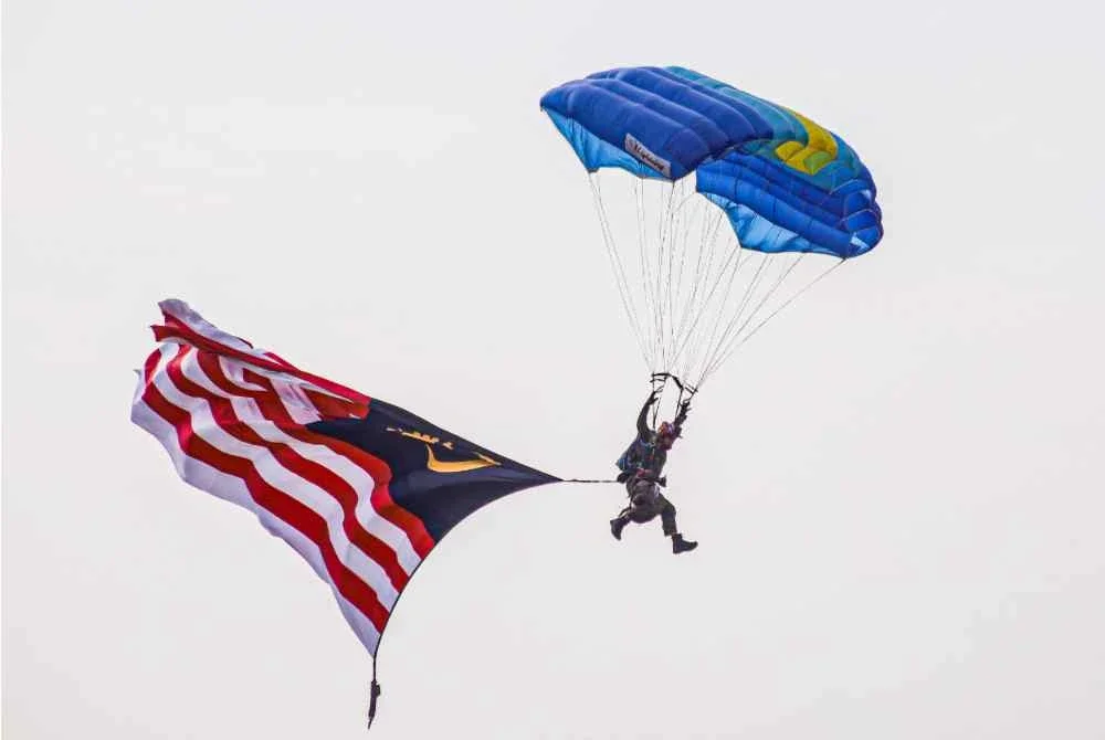 Jalur Gemilang dibuka pada ketinggian 4,000 kaki oleh Sarjan Udara Muhamad Firdaus Minhat yang mempunyai pengalaman 553 kali penerjunan. Foto Bernama