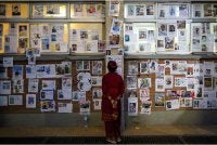Seorang wanita melihat gambar-gambar orang hilang susulan kejadian banjir kilat di Hospital Pengajaran Universiti Tribhuvan di Kathmandu pada Ahad - Foto: AFP